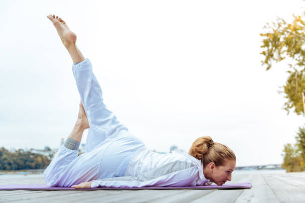 istock Relaxed young woman easily practicing yoga poses 1067181904