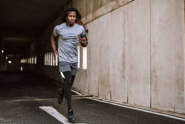 istock Young Man Running Through City He Lives In 1067192026