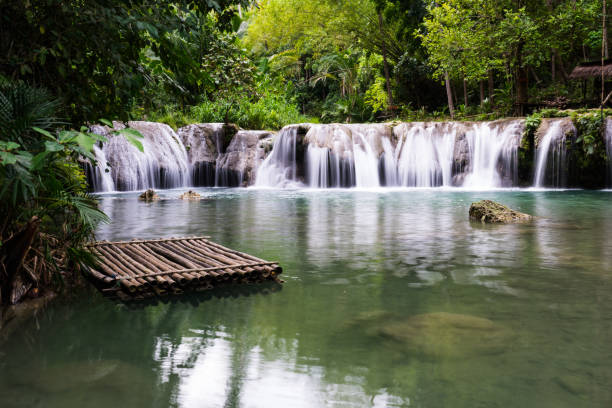 istock waterfall and bamboo raft in the stream 1067193768