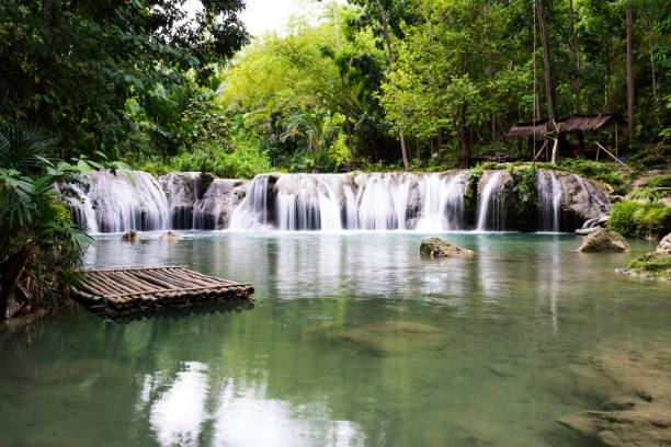 istock waterfall and bamboo raft in the stream 1067193770