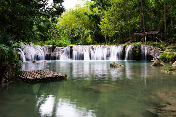 istock waterfall and bamboo raft in the stream 1067193852