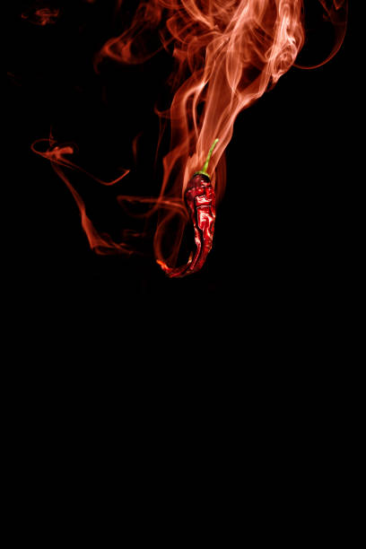 Hot chili pepper with red hot smoke