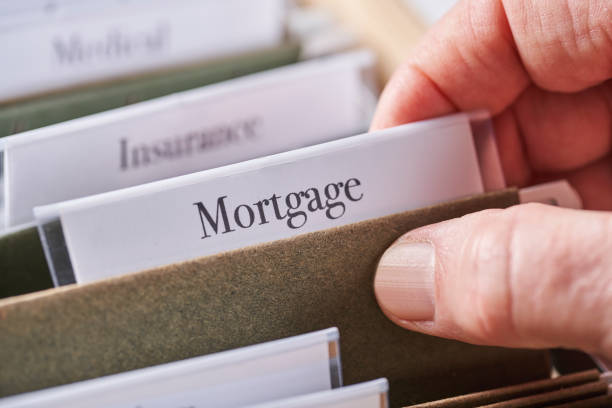 istock MORTGAGE: Files and folders in desk drawer with labels and tabs: Home office management 1067196616