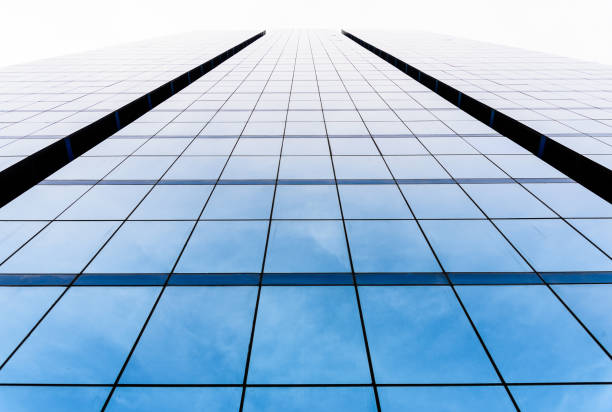 istock Bottom view of office building window close up with sunrise, reflection and perspective. 1067198812