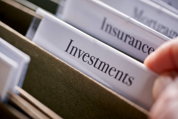 istock INVESTMENTS: Files and folders in desk drawer with labels and tabs: Home office management 1067198948