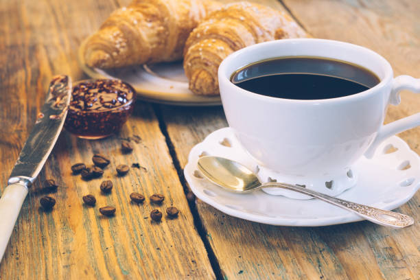 istock Black coffee and croissants with jam. Typical French Breakfast (Petit DÃ©jeuner) background. 1067203330