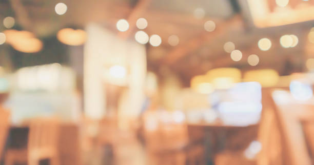 istock Restaurant interior with customer and wood table blur abstract background with bokeh light 1067203358