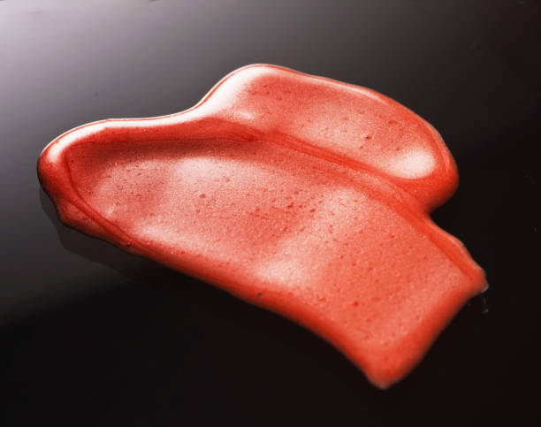 istock Texture of Red Lipgloss Liquid, Black Background 1067216526