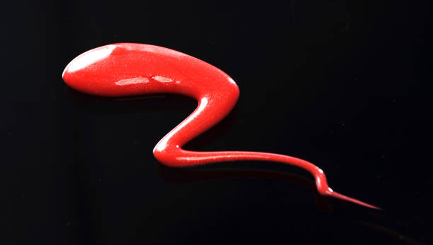istock Texture of Red Lipgloss Liquid, Black Background 1067216562