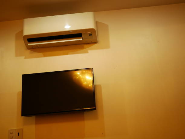 istock Air Conditioner on wall and display LED TV 1067236148