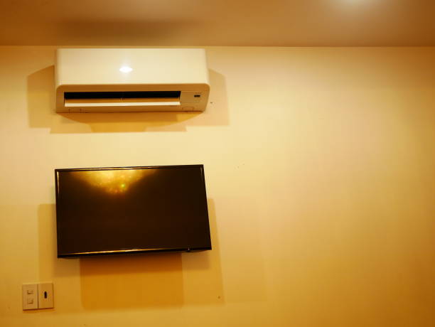 istock Air Conditioner on wall and display LED TV 1067236650