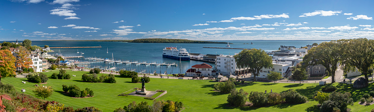 Mackinac Island, Michigan, USA - October 4, 2018: A panoramic shot capturing the vista of downtown Mackinac Island, shot from above the city.  A resort island located in Lake Huron, famous for fudge, horses and bicycles, there are no motorized vehicles allowed on the island.