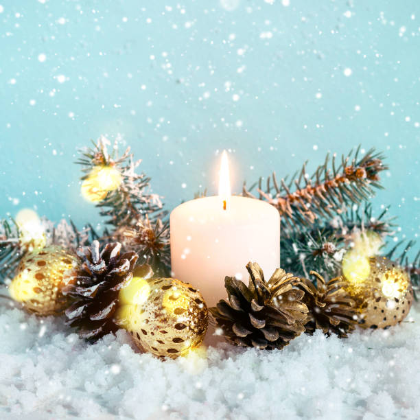 istock Christmas blue composition. Burning candle, conifers and cones on snow background 1067240850