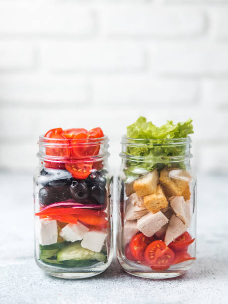istock Caesar salad and Greek Salad in glass mason jar 1067240884