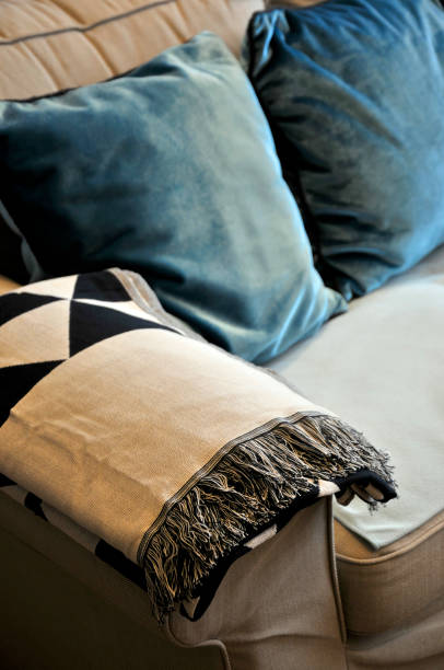 istock Beautiful colorful pillow and blanket etting on light gray comfy sofa 1067243318