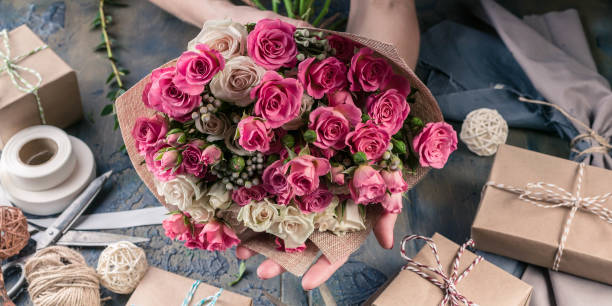 istock Web banner. Small business concept. Work process of florist. Female hands making wedding bouquet on a dark table 1067243486