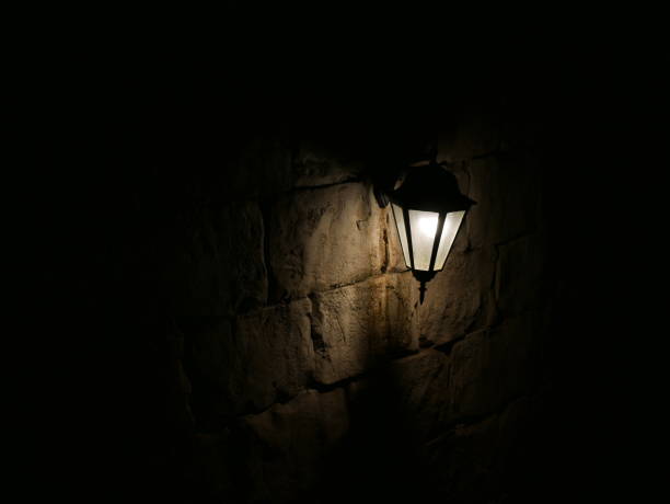 istock Closeup of a glowing lamp outside on wall 1067252466