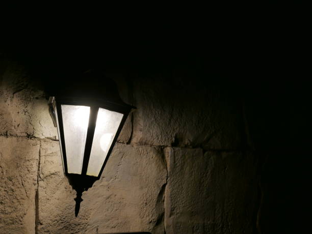 istock Closeup of a glowing lamp outside on wall 1067252470