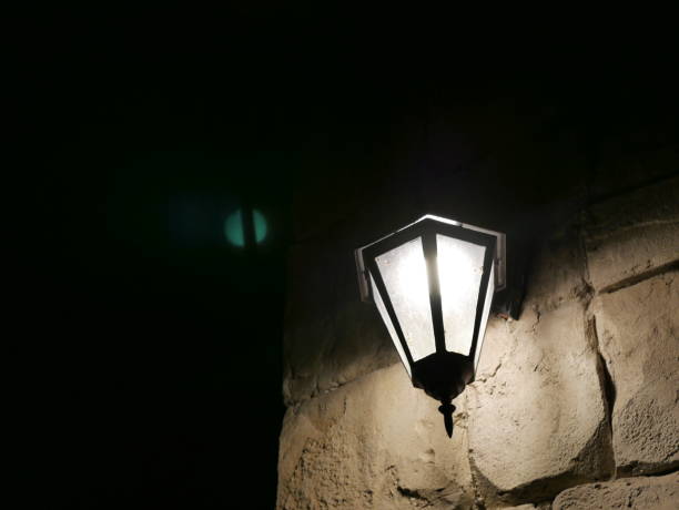 istock Closeup of a glowing lamp outside on wall 1067252548