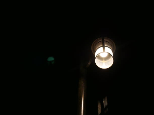 istock Closeup of a glowing lamp outside on wall 1067252566