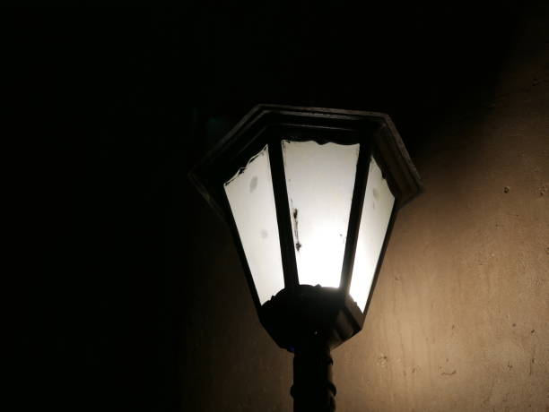 istock Closeup of a glowing lamp outside on wall 1067252712