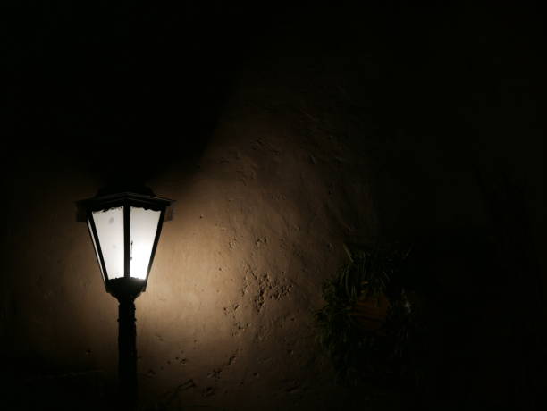 istock Old ornate LED street lamp against on wall 1067252732