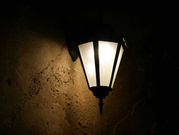 istock Old ornate LED street lamp against on wall 1067252770