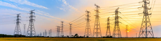 high-voltage power lines at sunset