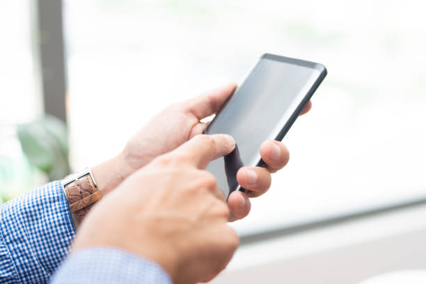 istock Closeup of man tapping on smartphone screen 1067263332