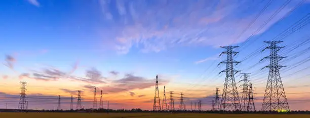 Photo of high-voltage power lines at sunset