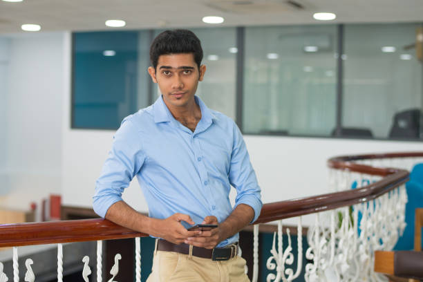 istock Content confident young man leaning on railing in modern office 1067269246