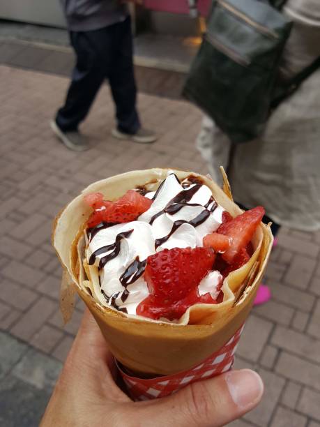 istock Strawberry chocolate and whipped cream rolled hand held crepe 1067271860