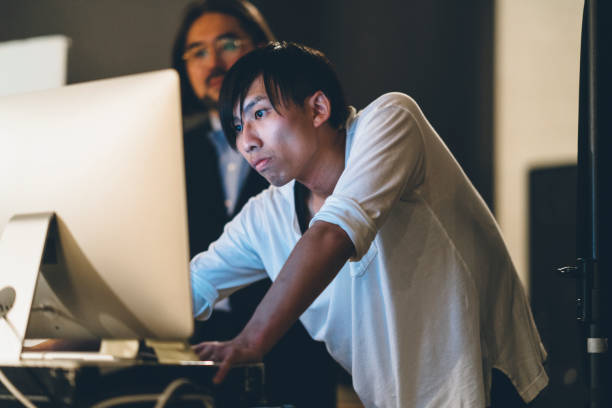 Photographer and his model cheking photos on computer