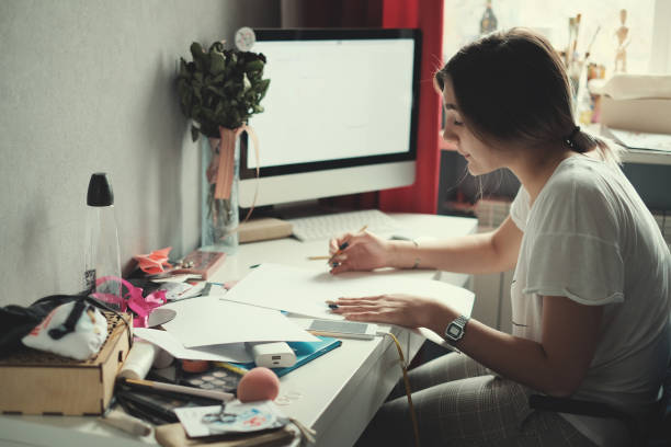 istock Teenage girl doing homework 1067281834