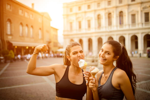 istock Two sporty women eating ice cream. 1067283840