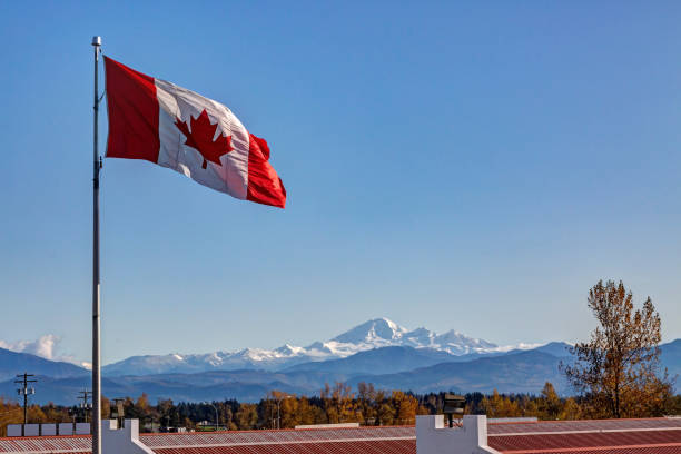 Canadian Flag with Mt. Baker in the background Canadian Flag with Mt. Baker in the background abbotsford canada stock pictures, royalty-free photos & images