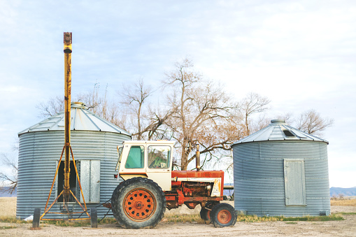 Backgrounds of Vintage Tractor and Metal Grain Storage Silos Rural Elements and Surfaces and Outdoor Textures Western Colorado