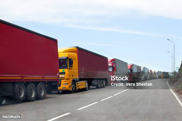 Queue Of Trucks Passing The International Border Red And Different Colors Trucks In Traffic Jam On The Road Stock Photo - Download Image Now