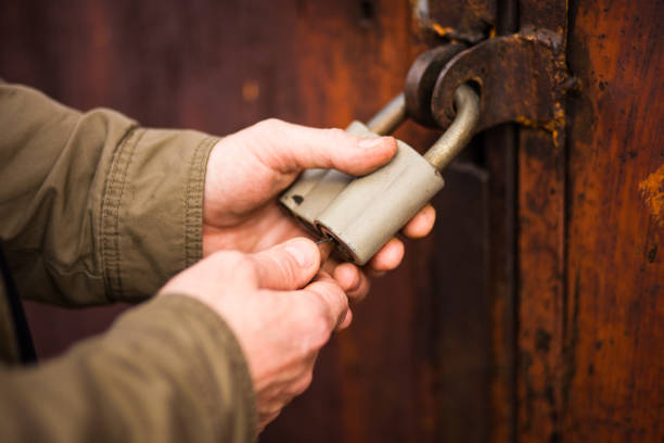 man's hands close the lock, unlocking an old padlock man's hands close the lock, unlocking an old padlock opening bridge stock pictures, royalty-free photos & images