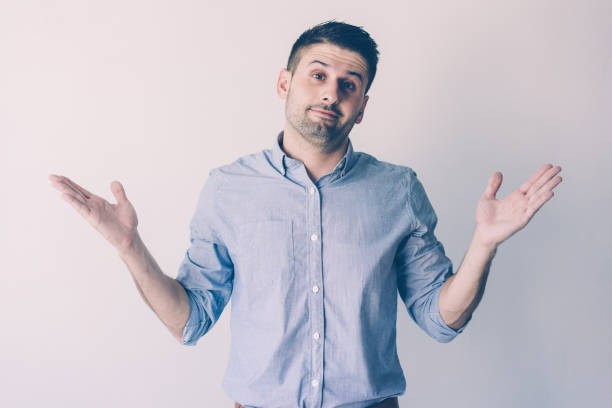 istock Misunderstanding handsome young businessman shrugging shoulders 1067302720
