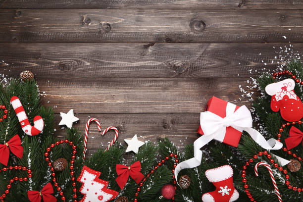 istock Christmas fir tree branches with decorations on wooden table 1067305316