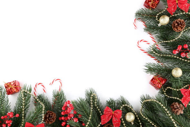 istock Christmas fir tree branches with candy canes and baubles on white background 1067305762
