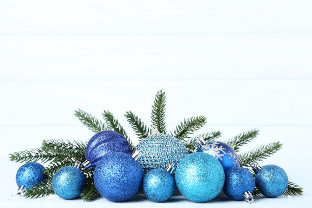 istock Christmas baubles with fir tree branches on wooden table 1067305832