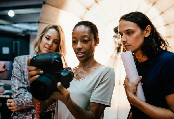 Photographers looking at photos on a camera