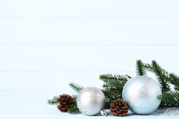 istock Christmas baubles with cones and fir tree branches on wooden table 1067307334