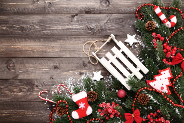 istock Christmas fir tree branches with decorations on wooden table 1067307712