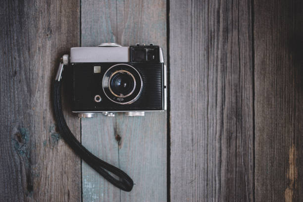 istock top view Vintage camera on dark wooden background 1067309858
