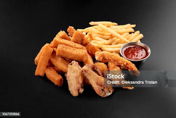 Fresh Beer Snacks Chicken Wings French Fries Cheese Sticks Assortment On Black Stock Photo - Download Image Now
