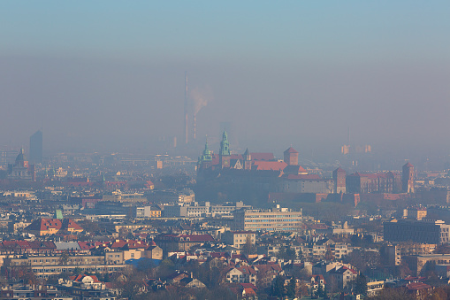 Dense smog over the city, air pollutant, aerial view of the old town Krakow, Wawel Castle, Poland