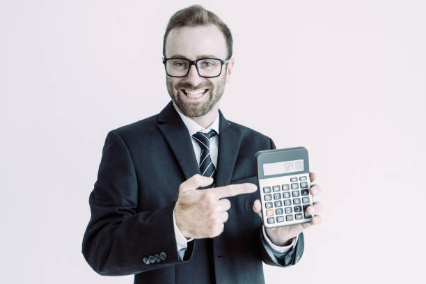 istock Smiling business man holding and showing calculator display 1067315264